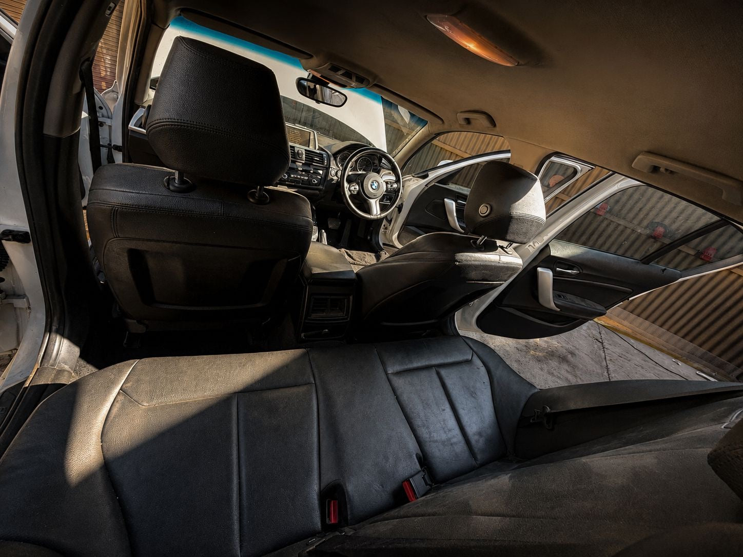 Interior of a vintage car with a focus on the dashboard and steering wheel.