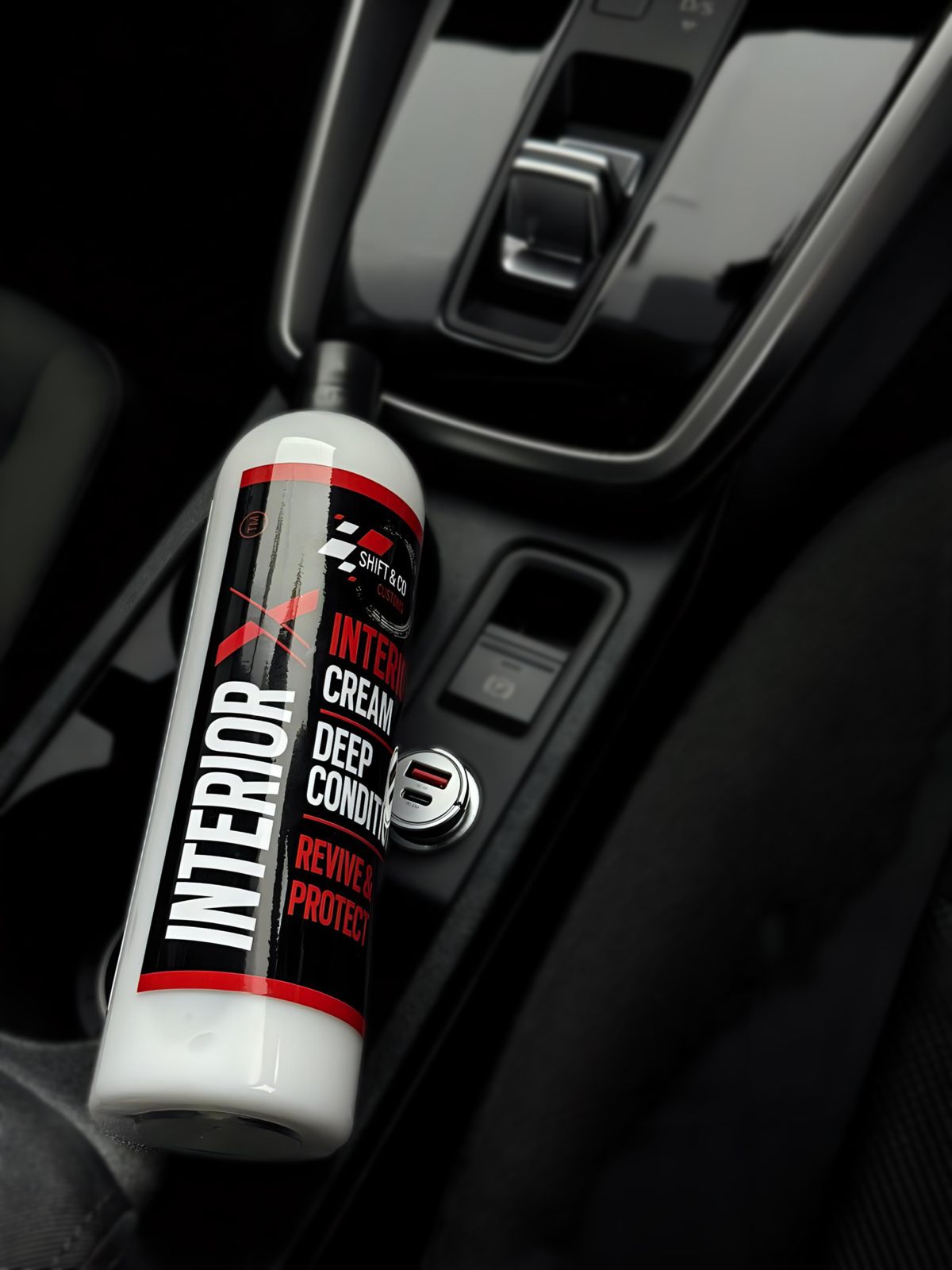 Car interior care product with visible branding on a car dashboard.