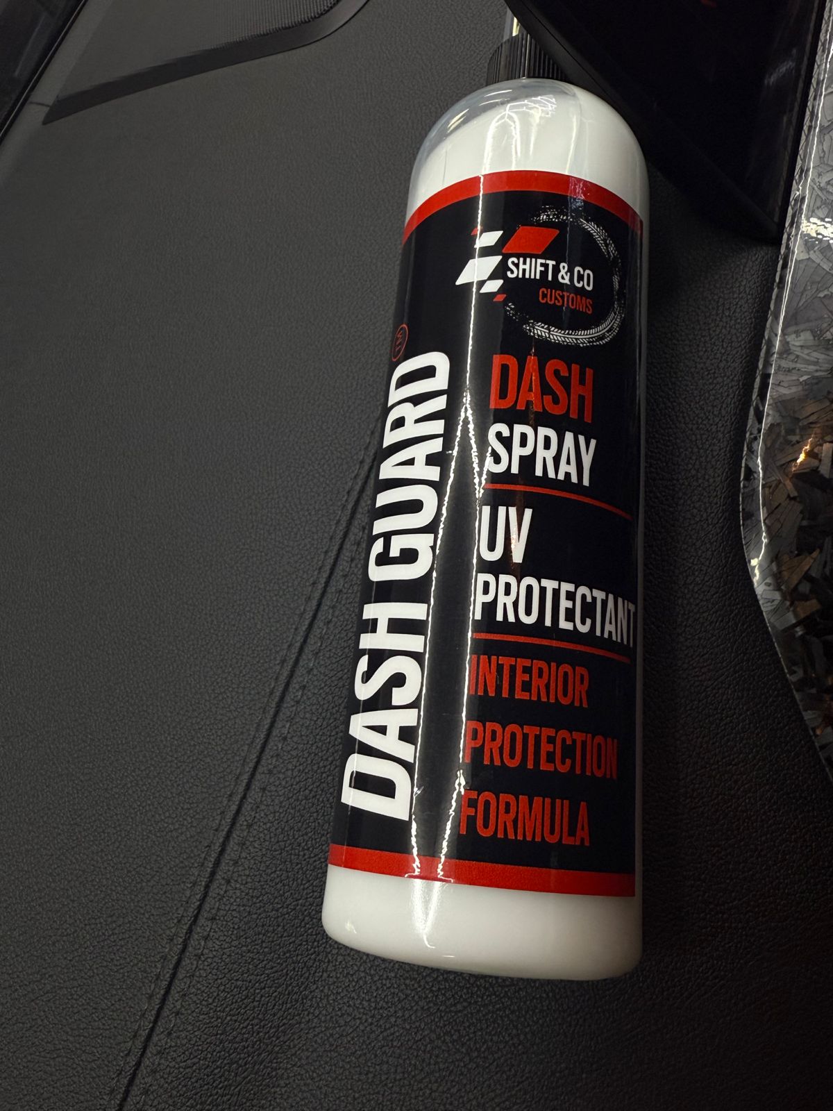 Dash Guard spray bottle on a car dashboard