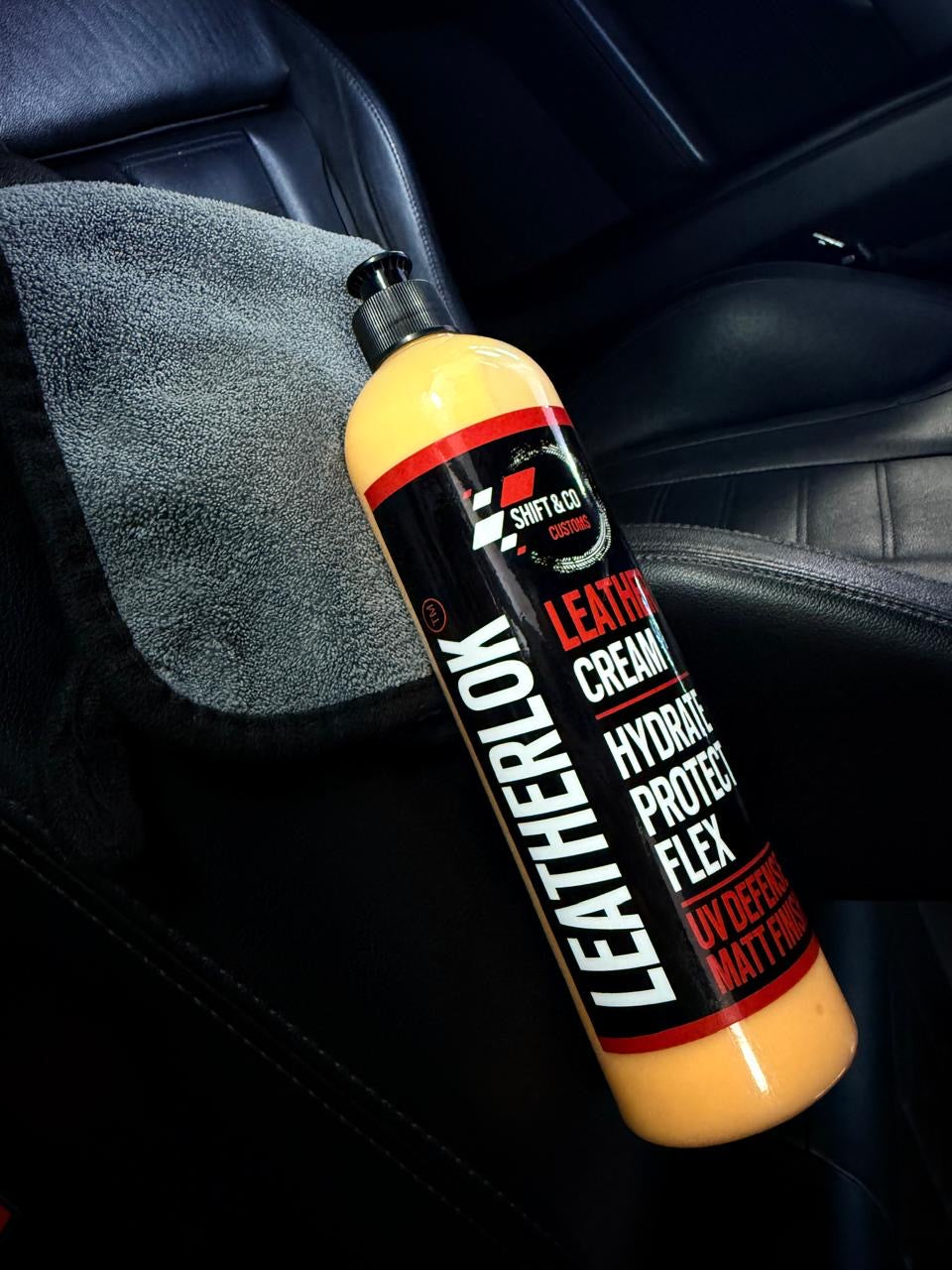 Bottle of Leatherlok leather cream on a car seat