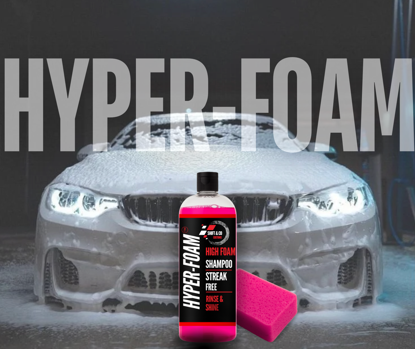 Car being washed with a bottle of 'Hyper Foam' shampoo and a pink sponge in front of it.