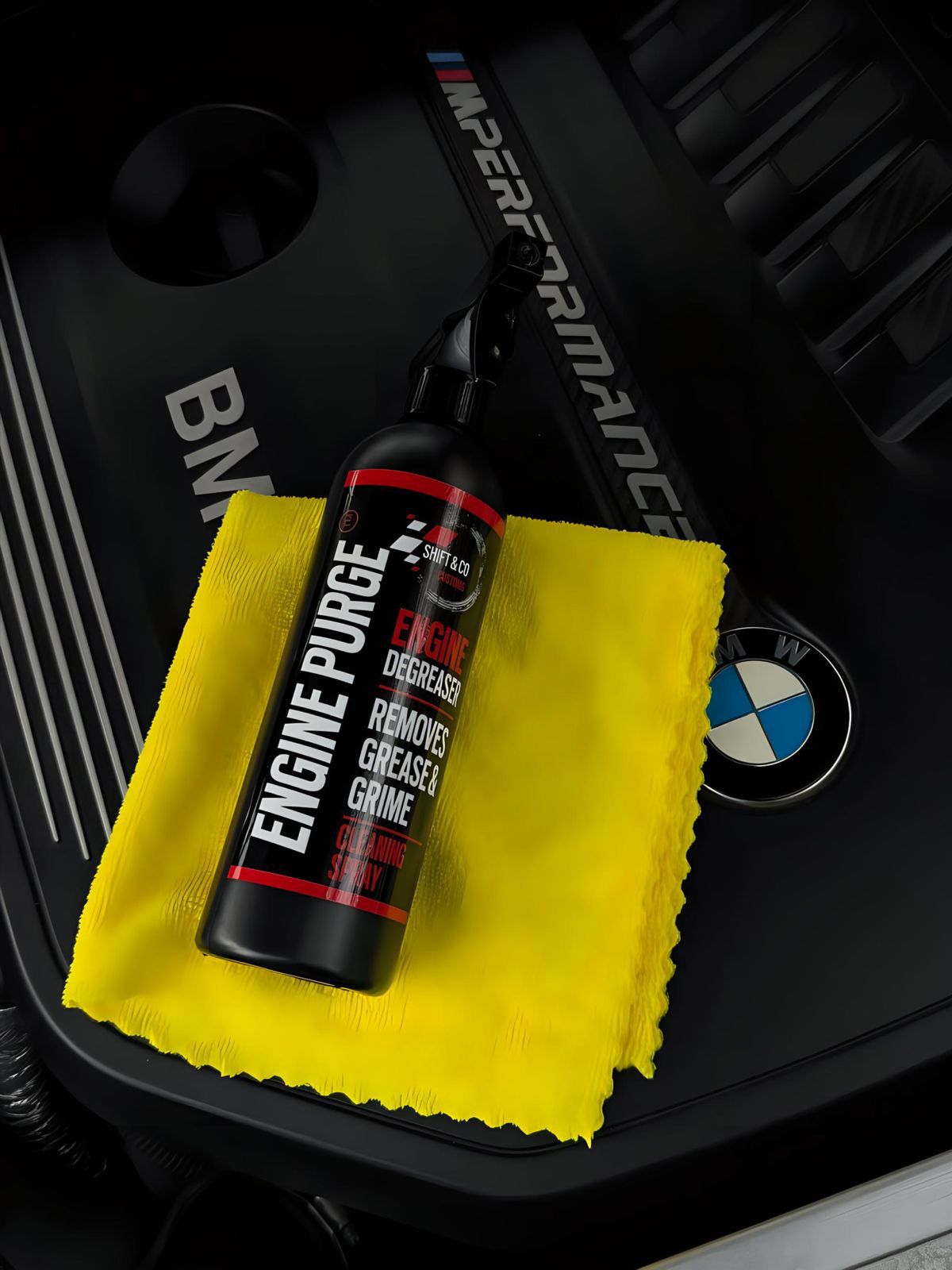 Engine purge cleaner bottle on a yellow cloth with BMW logo in the background